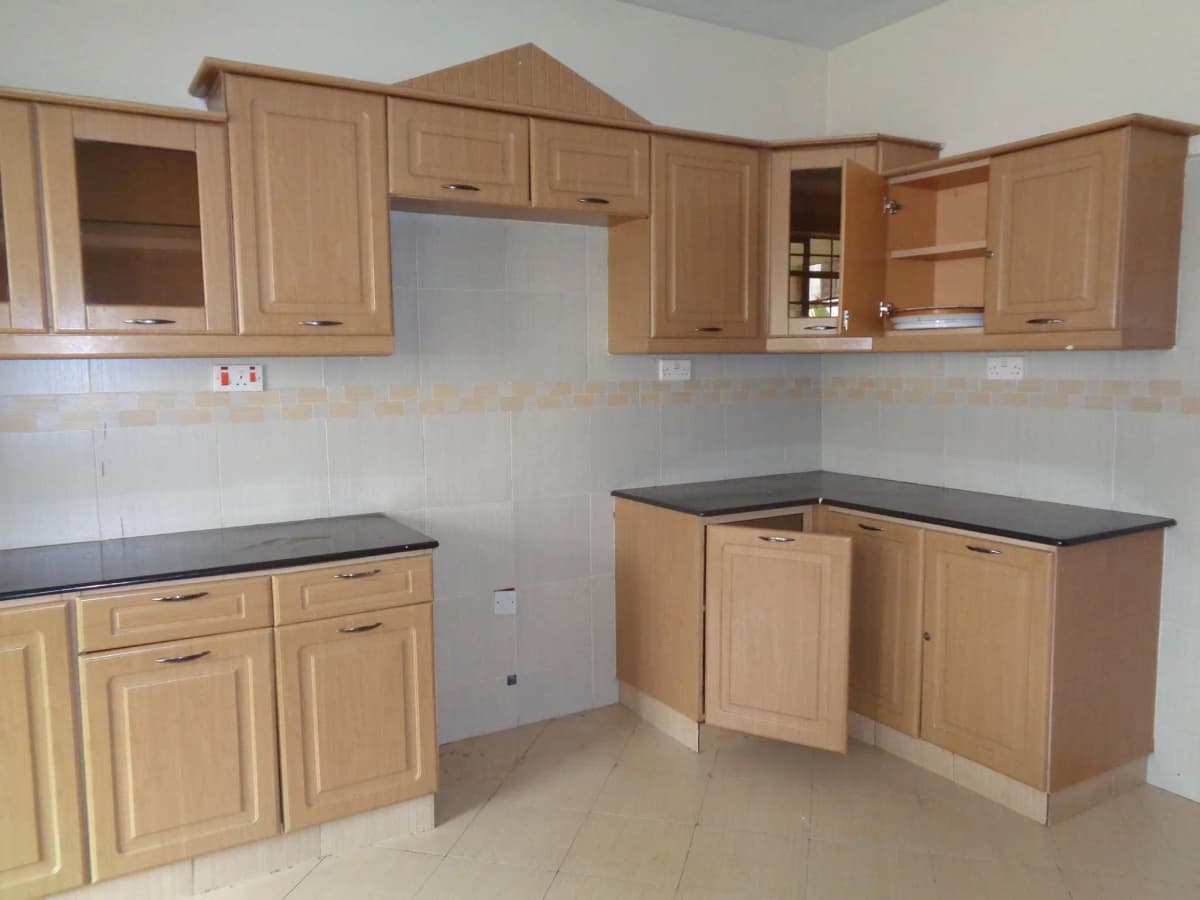 Unfurnished kitchen with wooden cabinetry and dark countertops