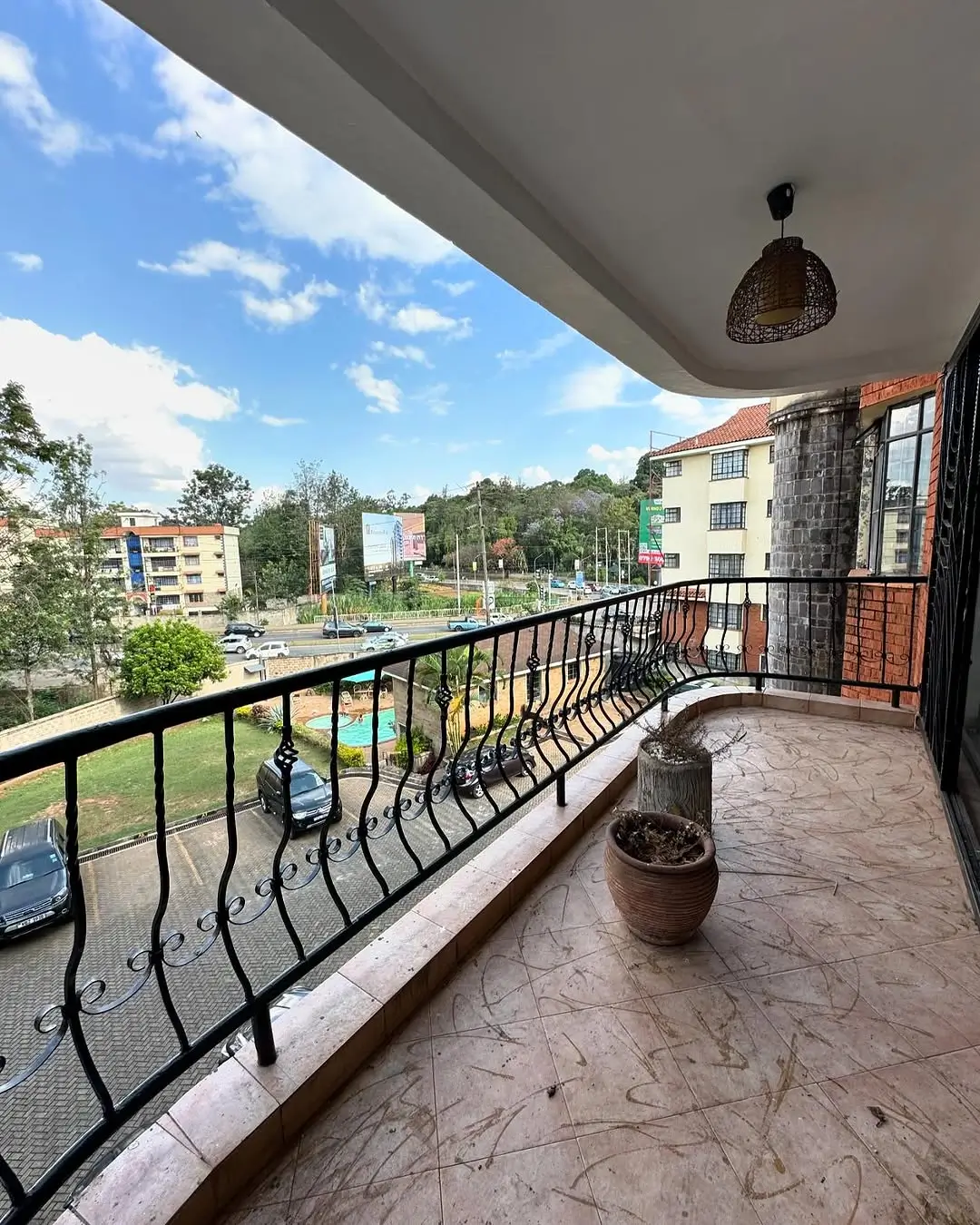 Spacious balcony with city views and potted plants