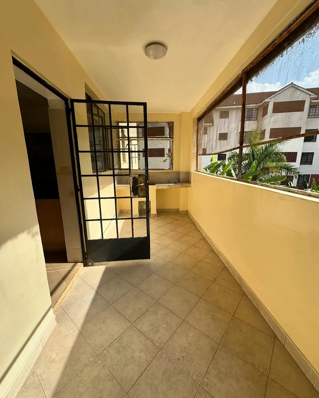 Covered balcony with tile flooring and city views