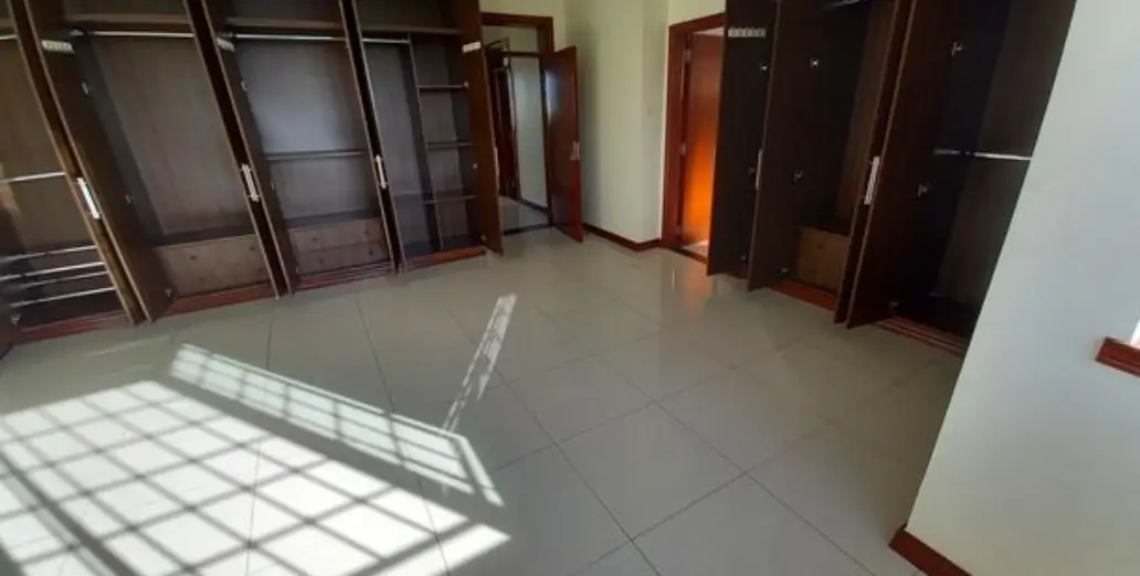 Spacious lobby with polished floor and multiple dark wooden doors