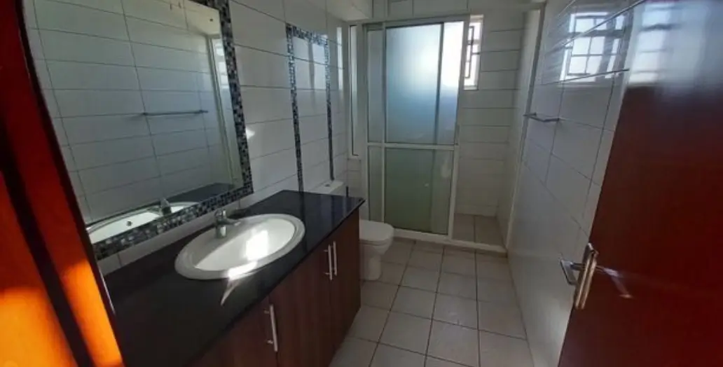 Modern bathroom with double vanity and enclosed shower cubicle