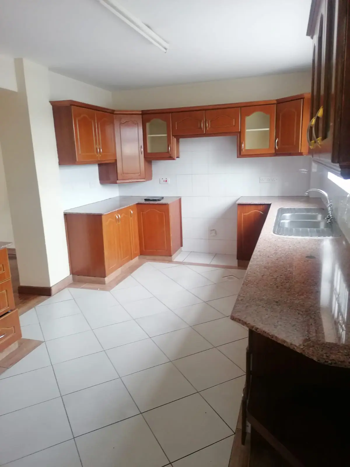 Spacious kitchen with wooden cabinetry and stainless steel appliances