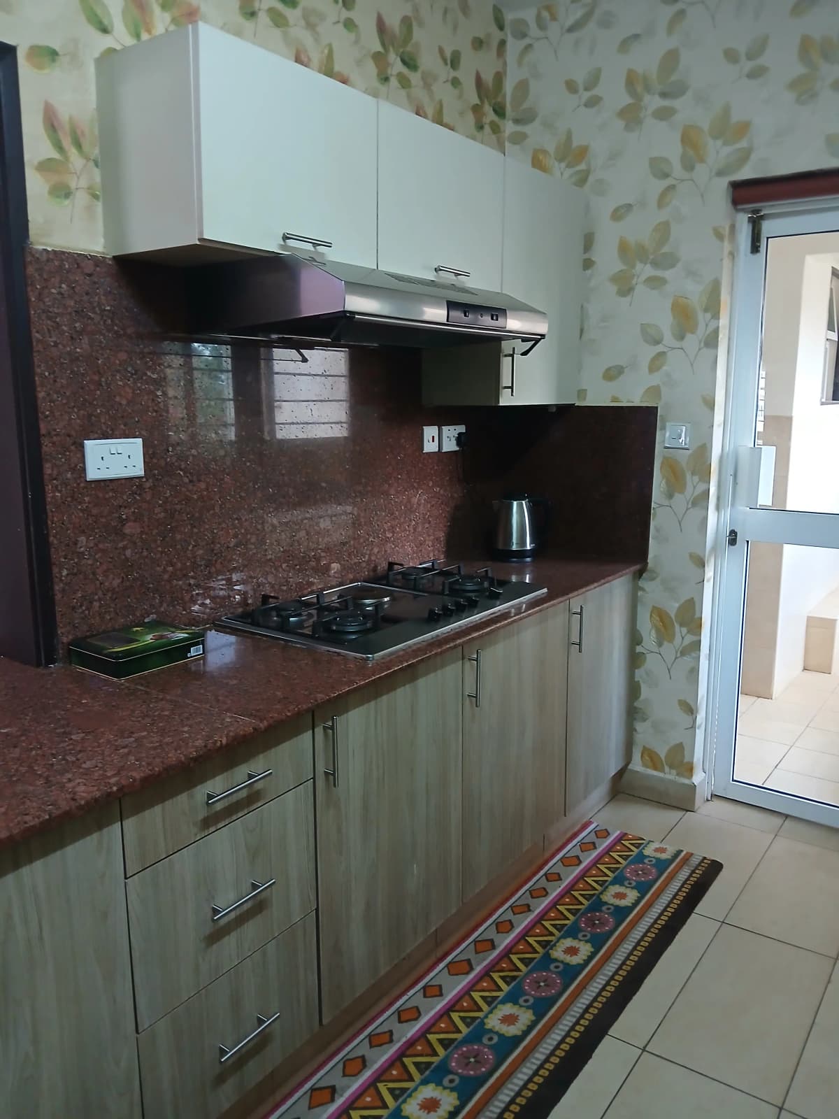 Compact kitchen with granite countertop and gas cooktop