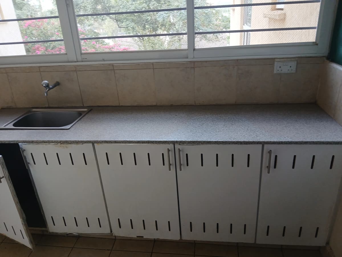 Utility storage room with sink and cabinet units