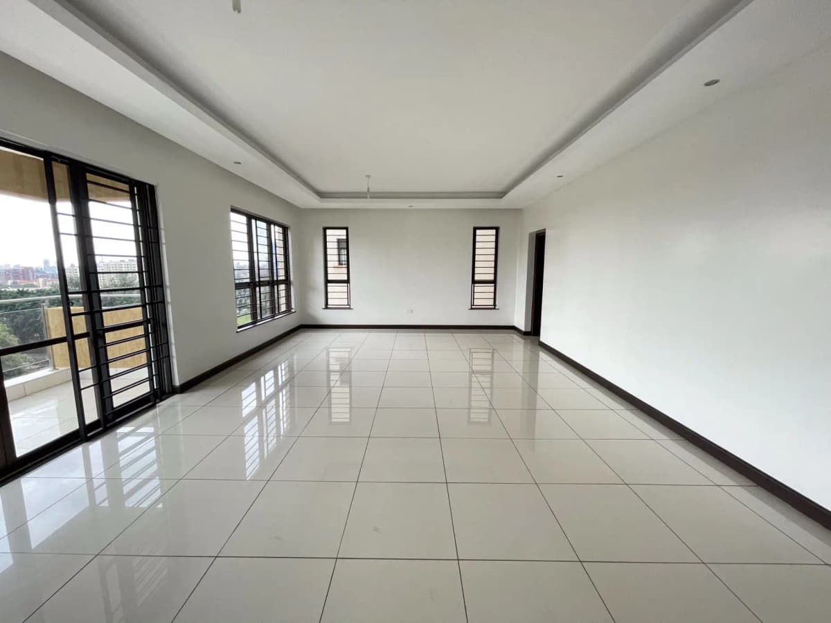Spacious open-plan living area with polished tile flooring