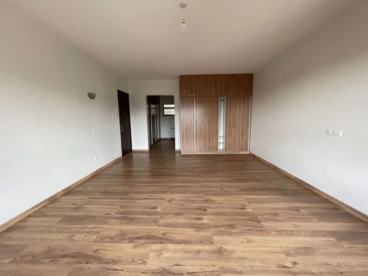 Spacious empty living room with wooden flooring and modern doors