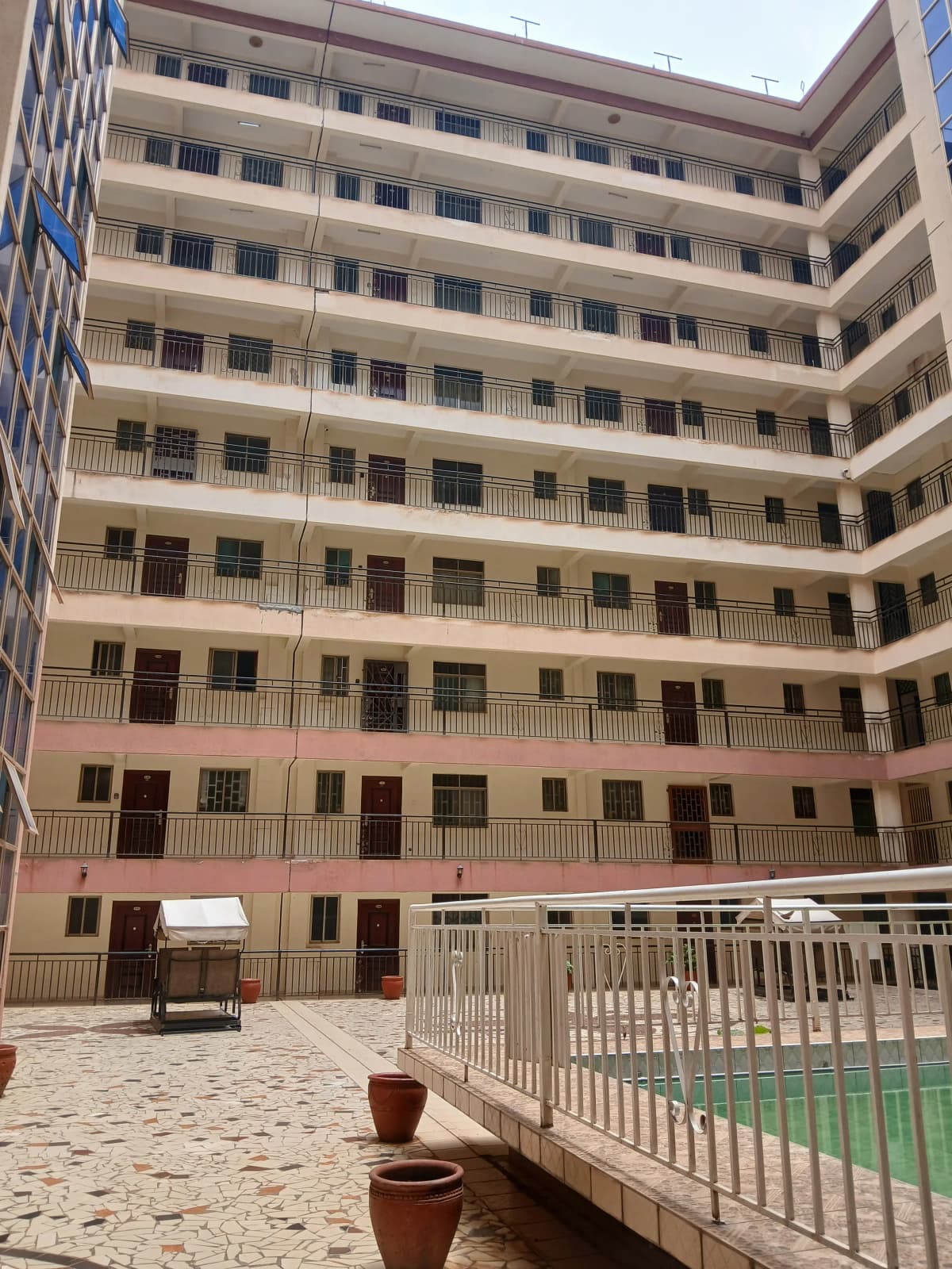 Multi-story residential building with interior courtyard and playground