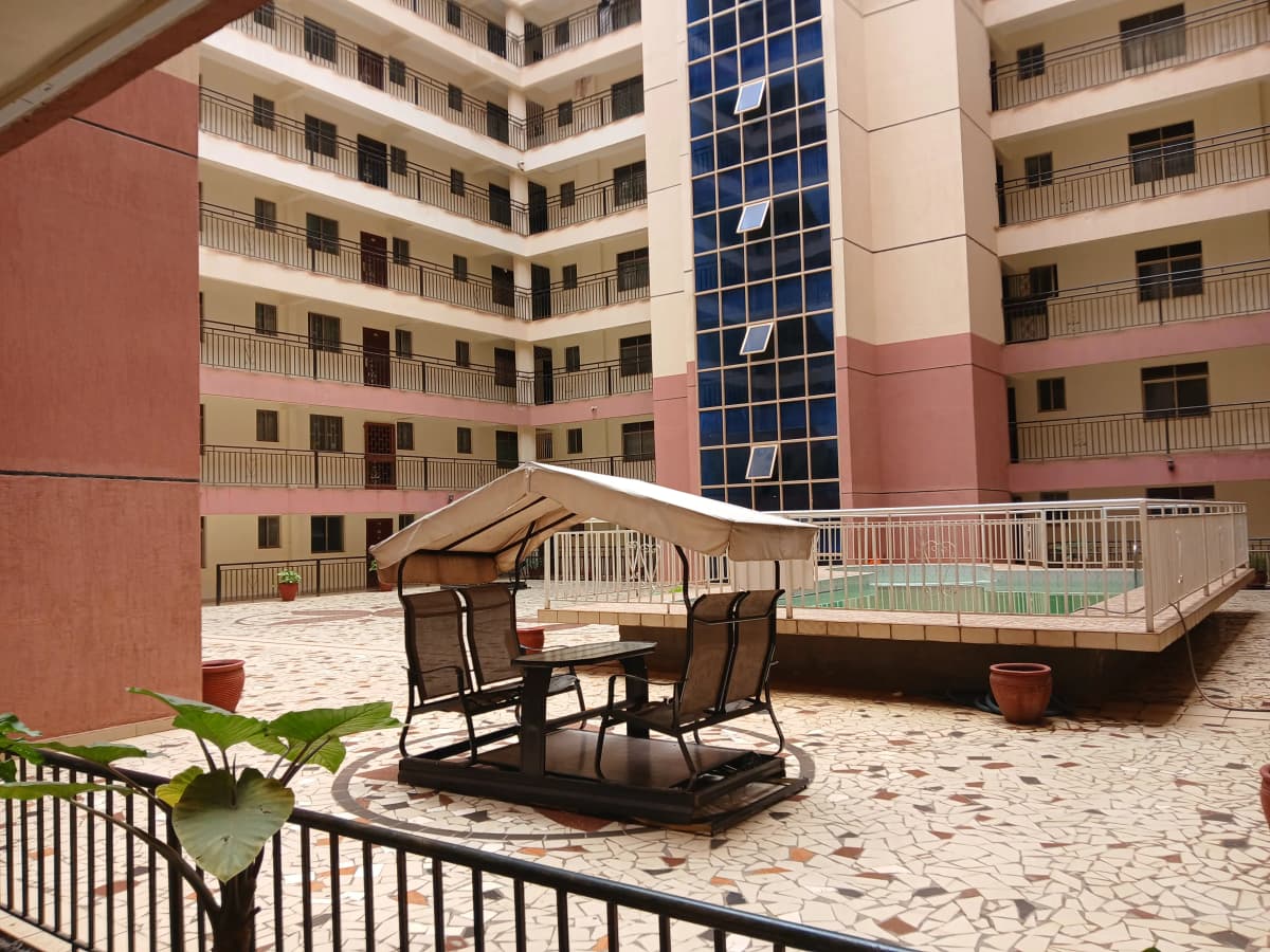 Communal courtyard with seating, landscaping, and pool access