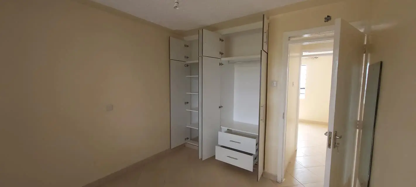 Bright bedroom with built-in wardrobes and natural light