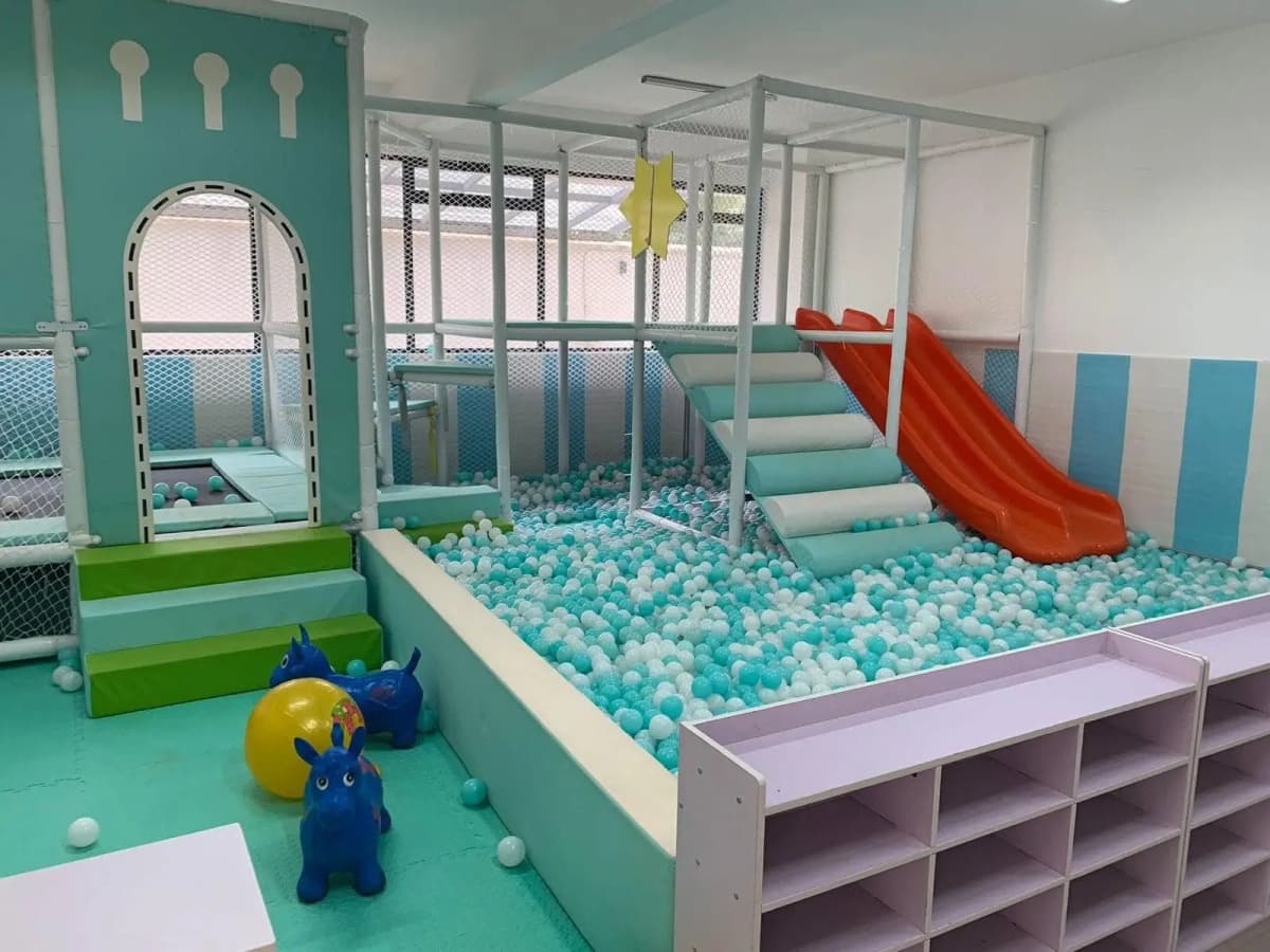 Indoor play area with ball pit, slide, and climbing structures