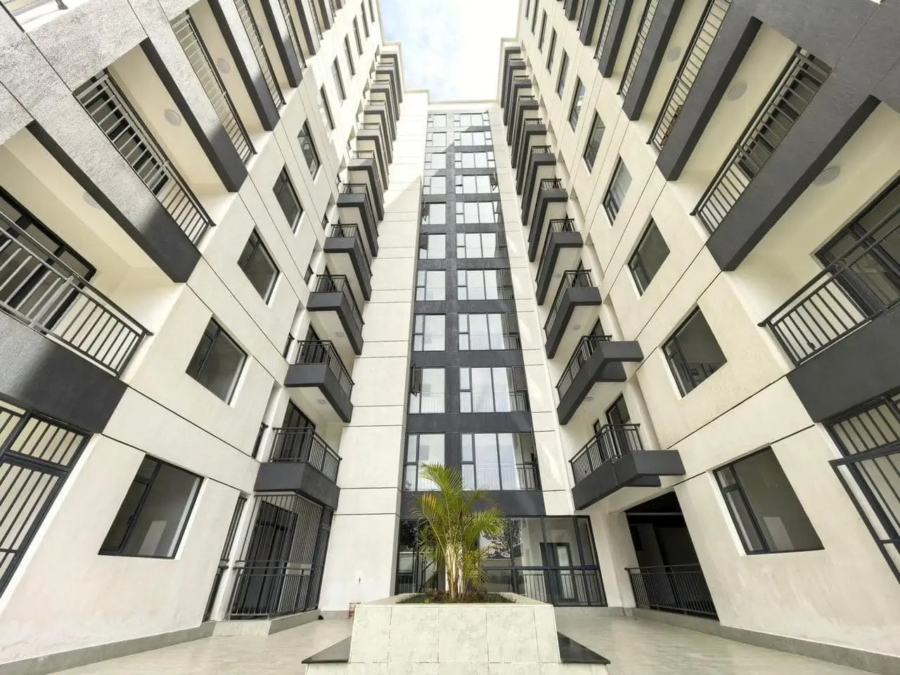 Modern multi-story residential building courtyard with symmetrical architecture