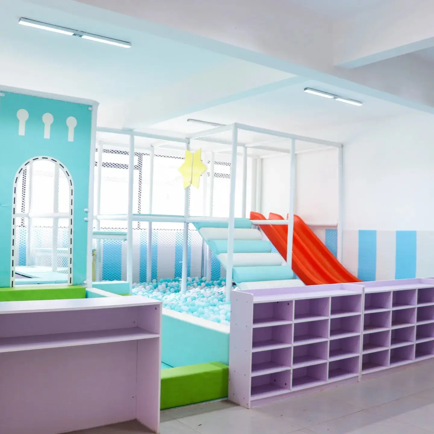 Colorful children's playroom with ball pit and storage cubbies