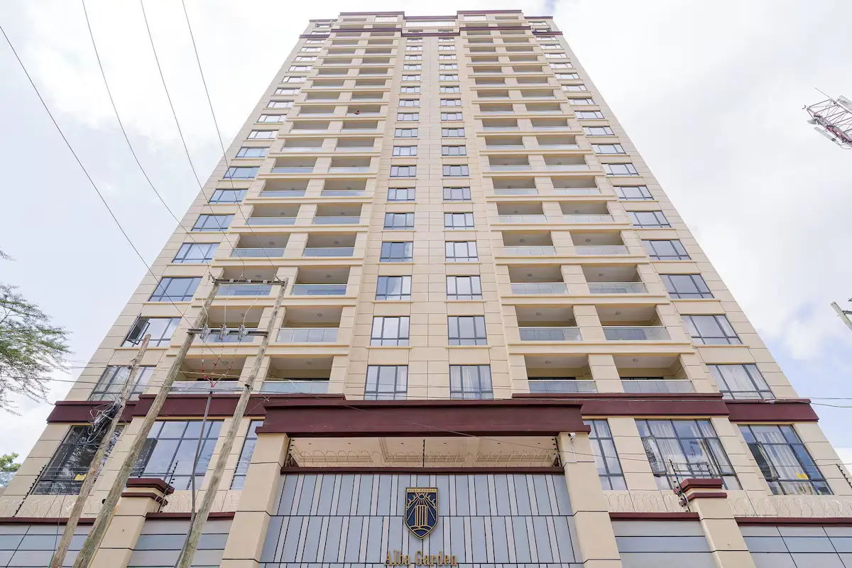 Multi-story residential building facade with balconies and ground-floor retail