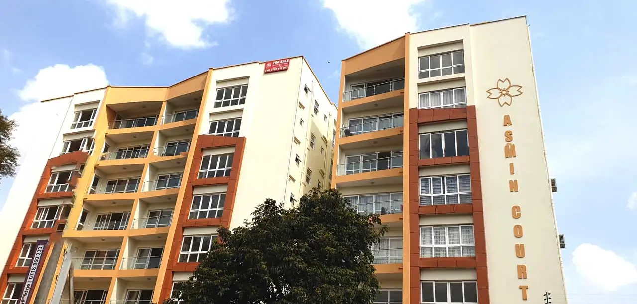 Multi-story residential building facade with orange and cream panels