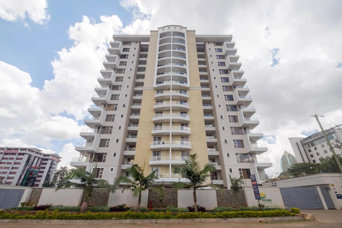 Modern multi-story residential building with landscaped compound