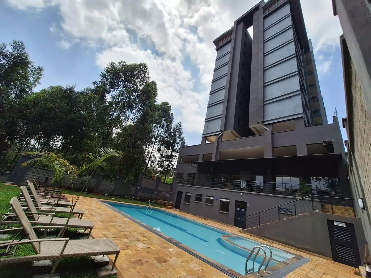 Modern swimming pool with loungers and residential tower backdrop