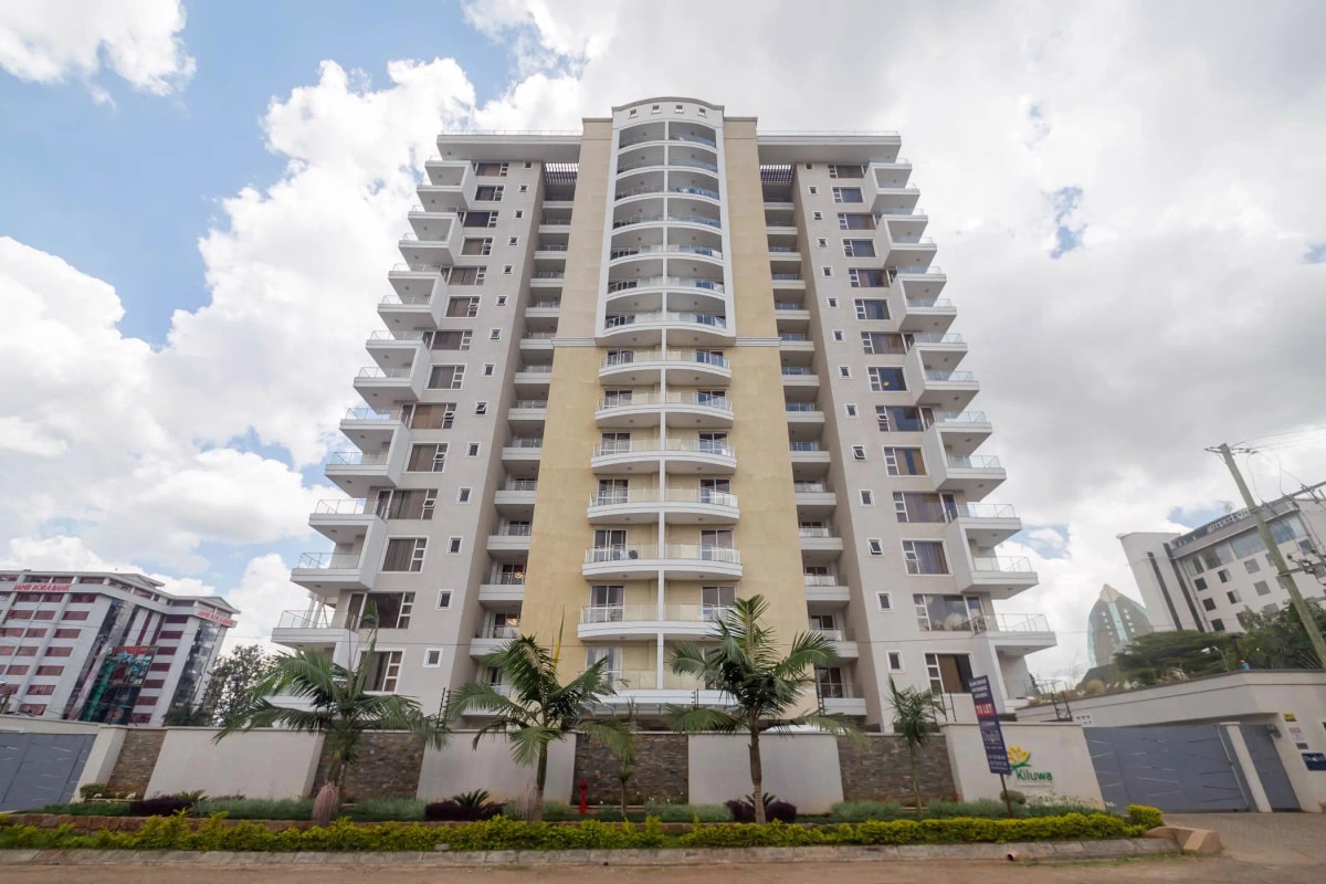 Modern multi-story residential building with landscaped compound