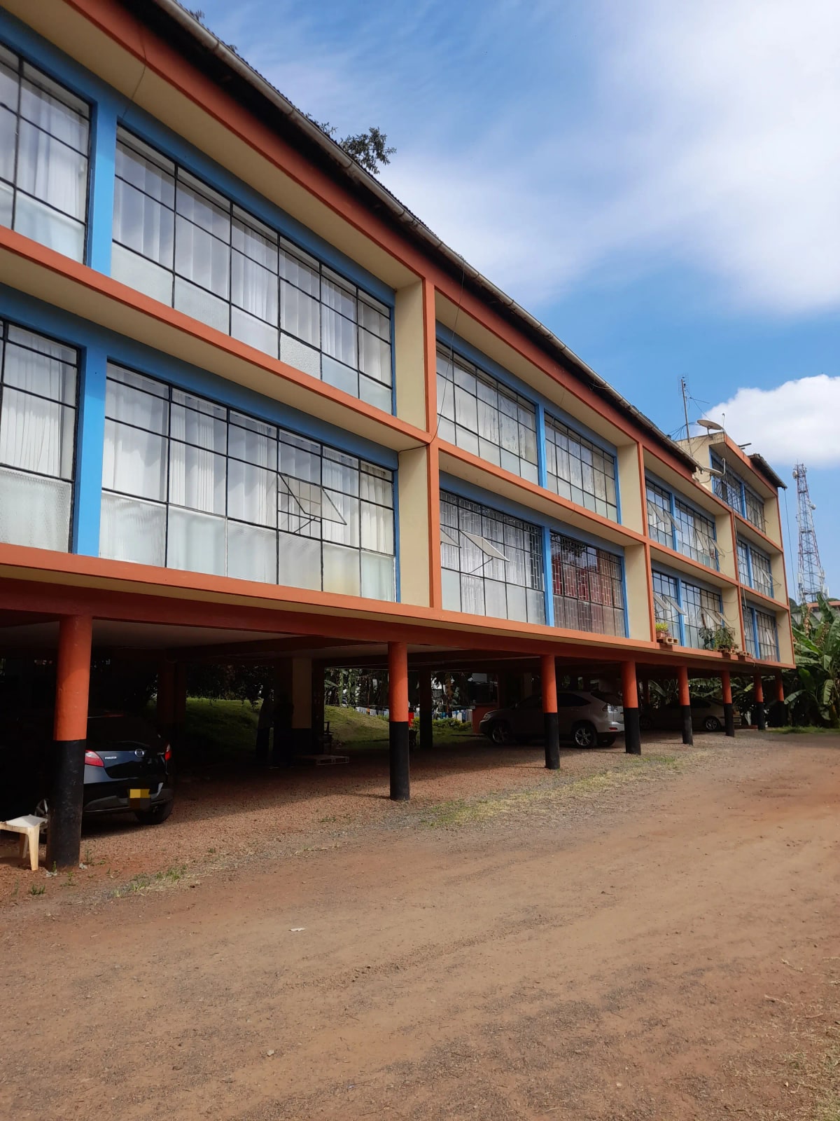 Multi-story building facade with ground-level covered parking