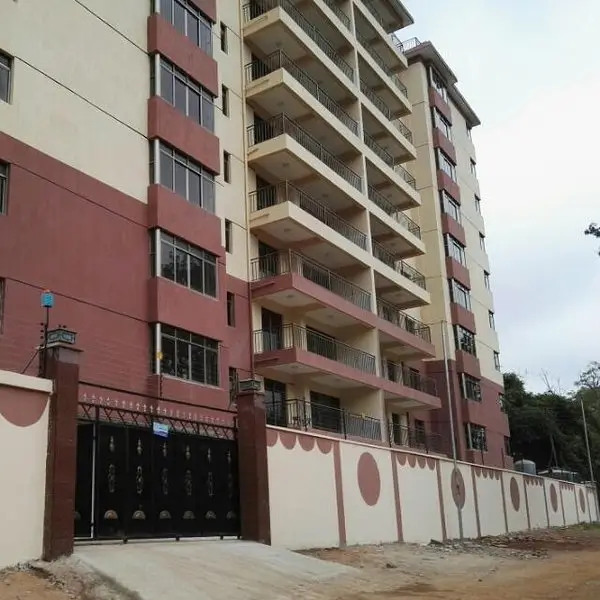 Modern multi-story residential building with red and white facade