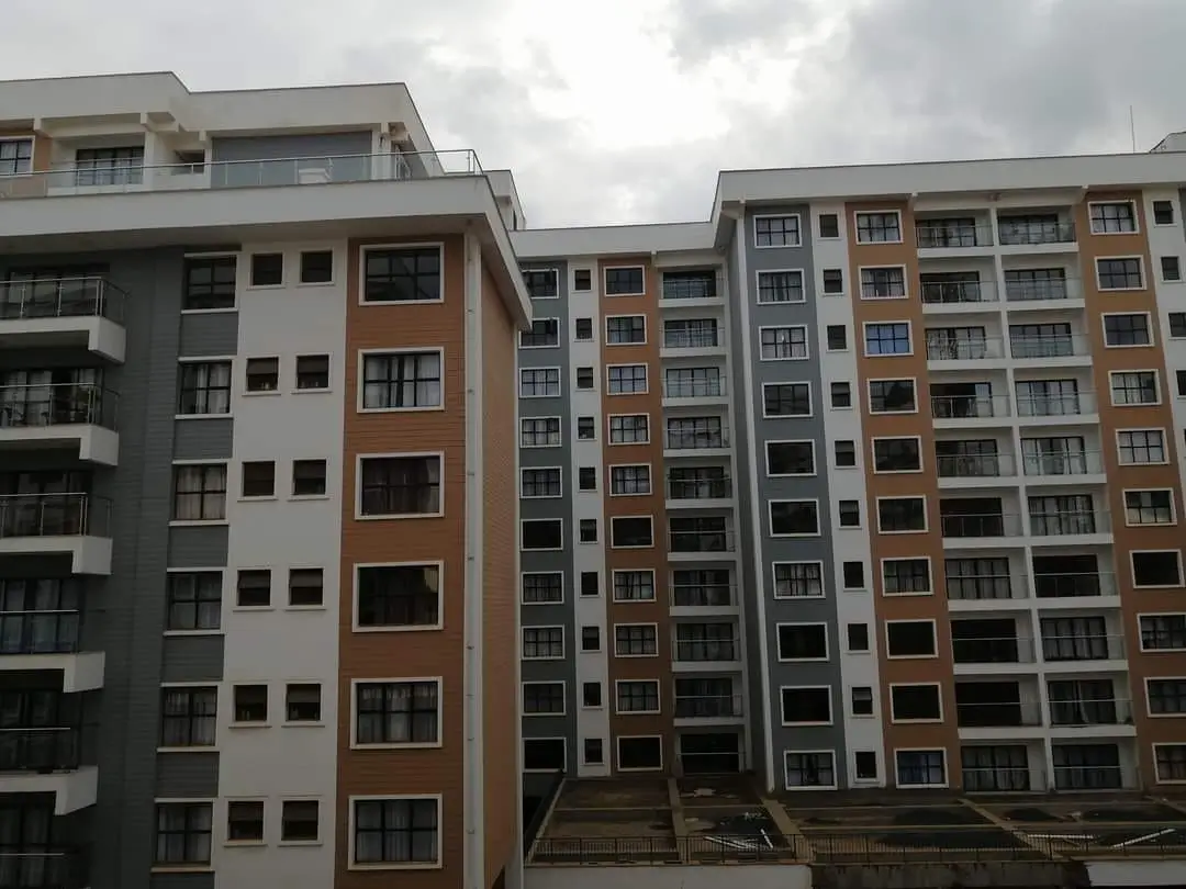 Modern multi-story residential building facade with varied color panels