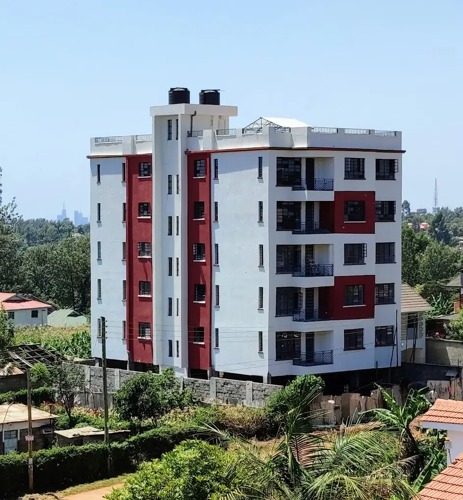 Modern multi-story apartment building with red and white facade