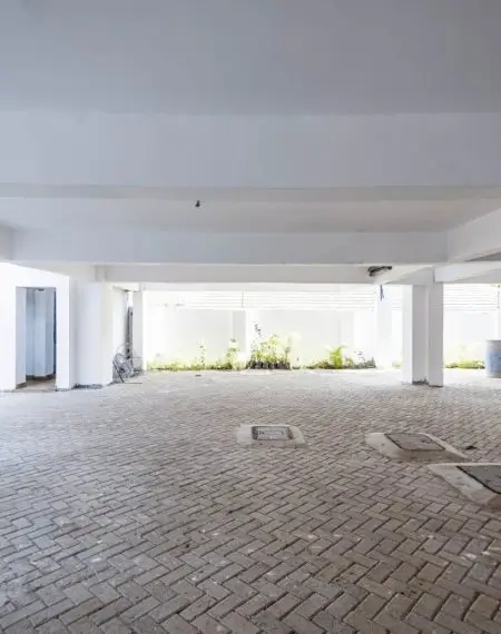 Covered parking bay with brick flooring and natural light