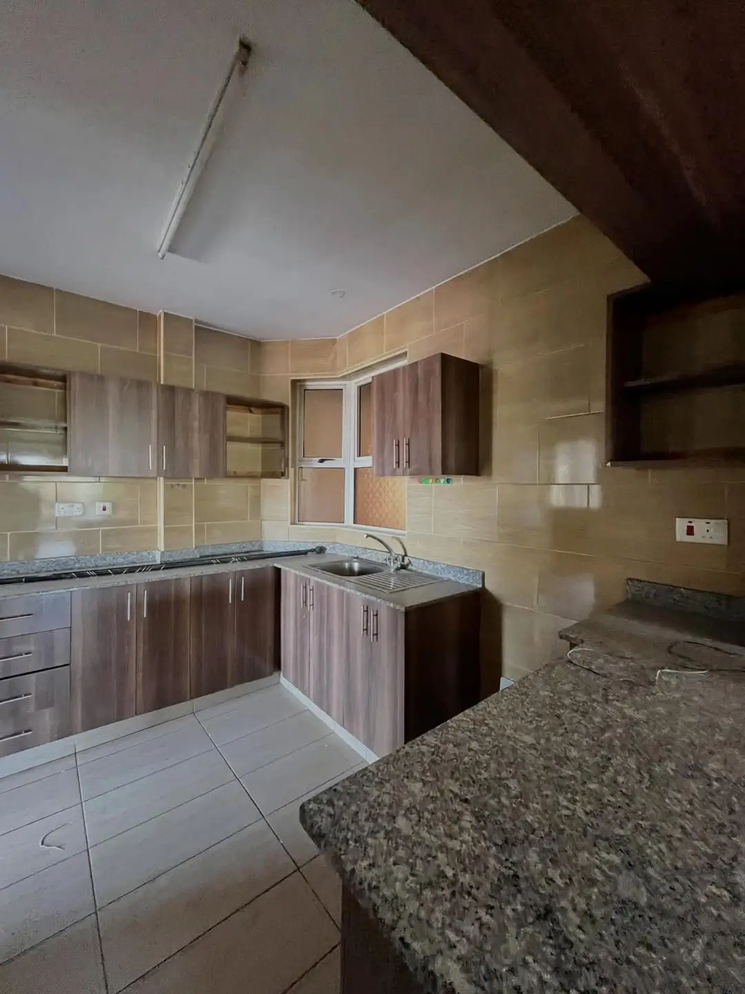 Modern kitchen with dark wood cabinets and granite countertops