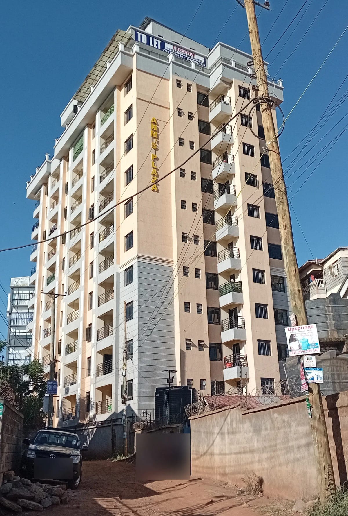 Multi-story residential apartment building with cream facade