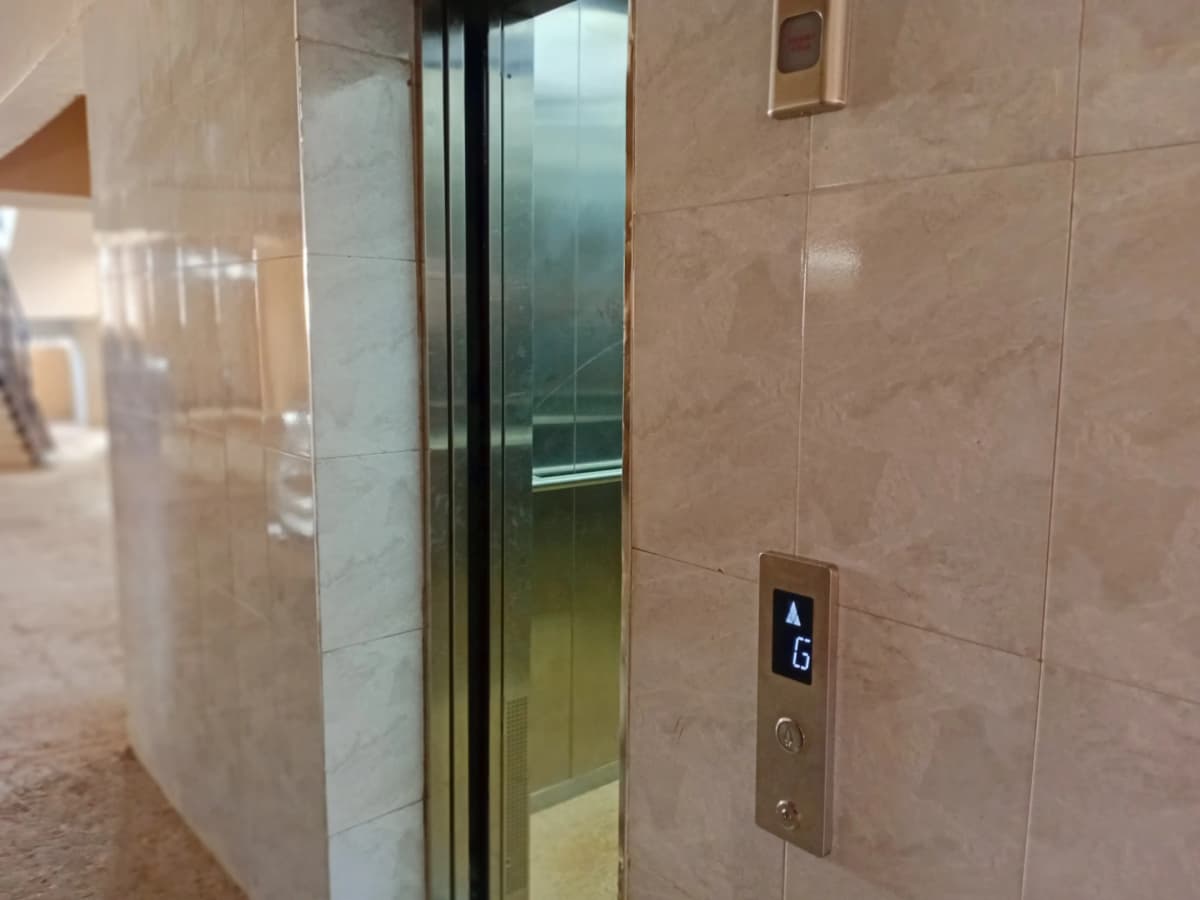 Building elevator with floor buttons and glass doors
