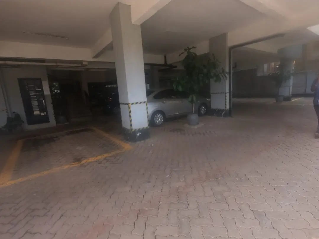 Covered parking bay with vehicle parked under carport