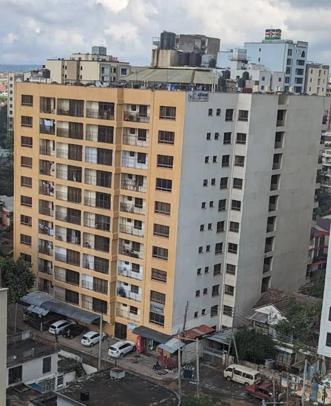 Multi-story residential building facade with yellow and gray units