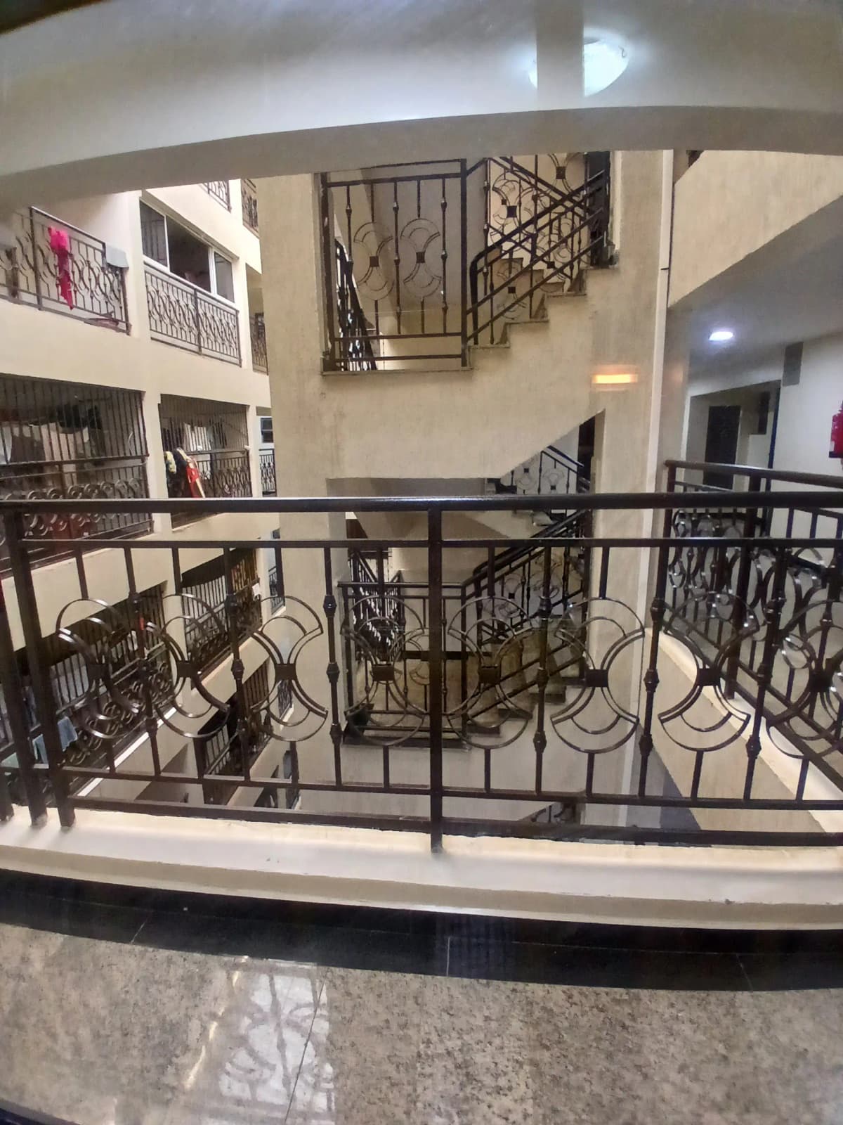 Multi-level lobby with curved balconies and metal railings
