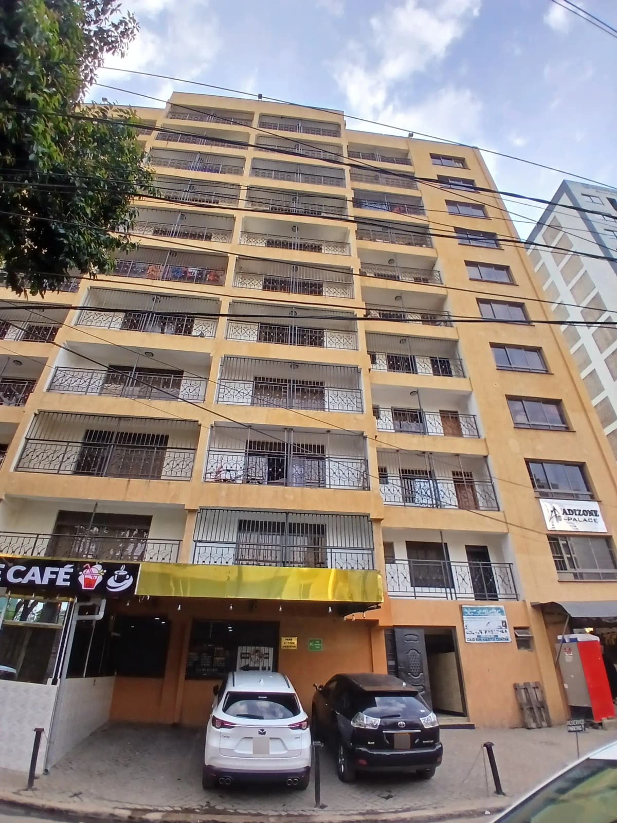 Multi-story residential building with yellow facade and balconies