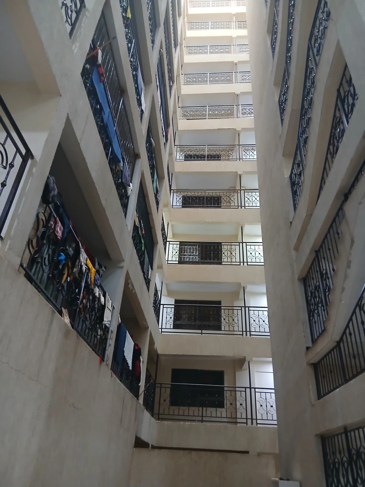 Multi-story apartment building interior courtyard with balconies