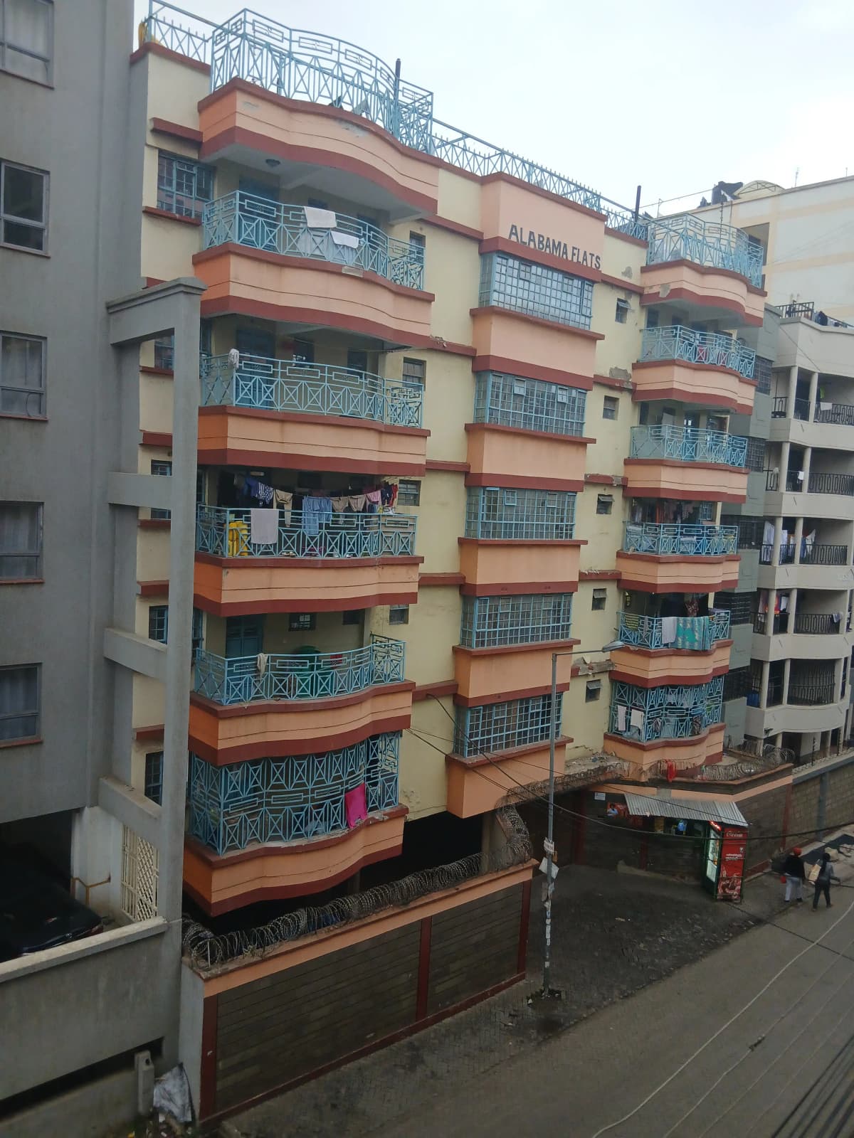 Multi-story residential building facade with orange and cream exterior