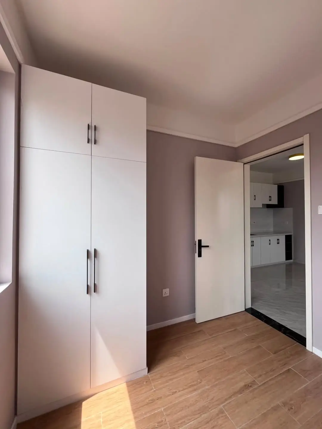 Spacious bedroom with built-in wardrobe and wooden flooring