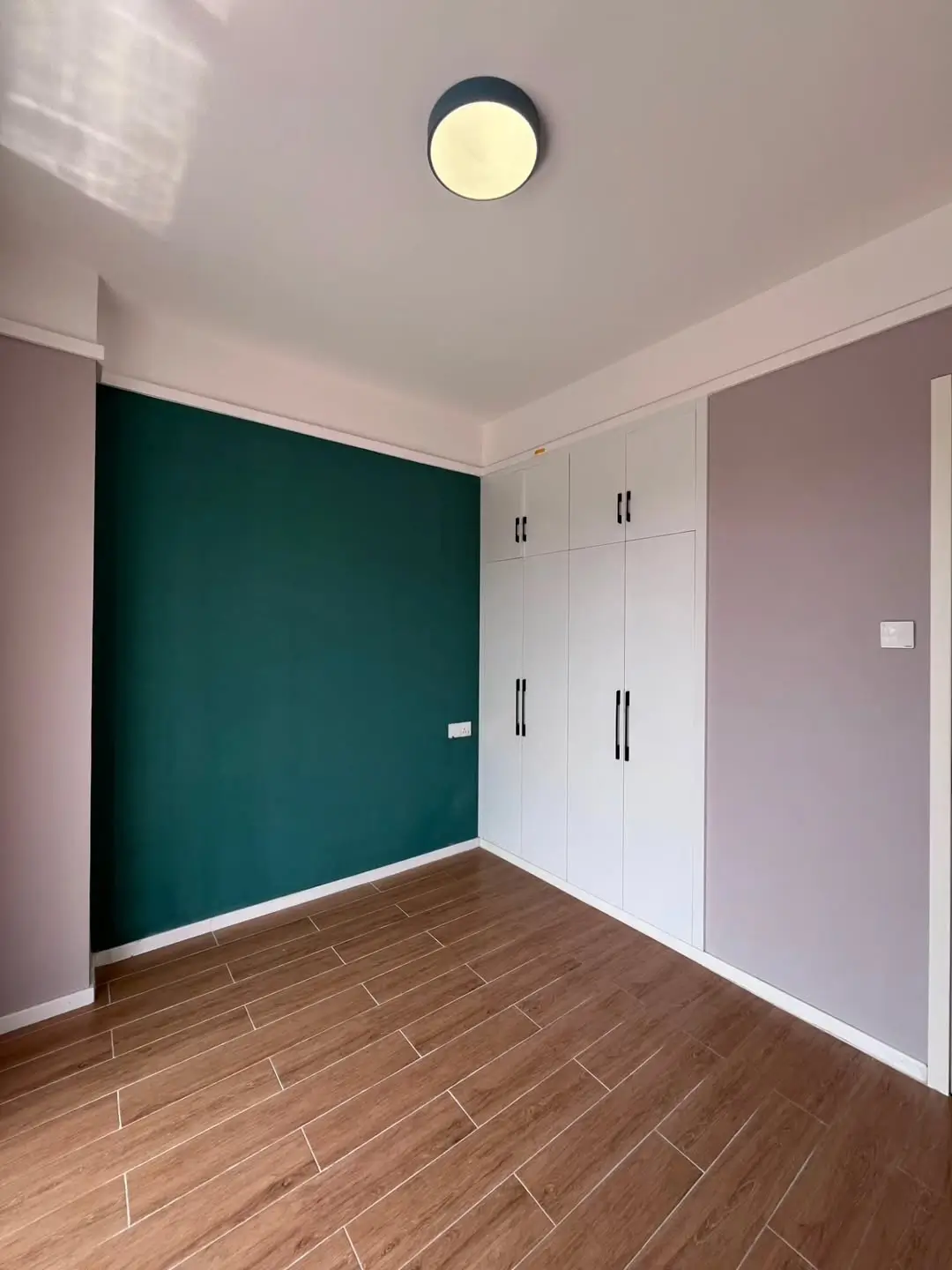 Bedroom with built-in wardrobes and feature wall
