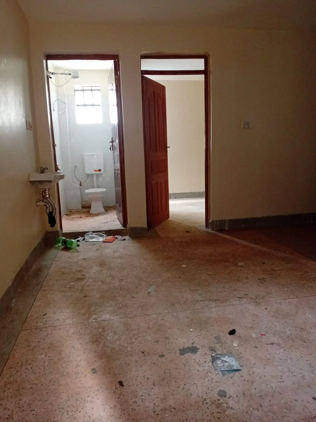 Empty bedroom with open bathroom door visible