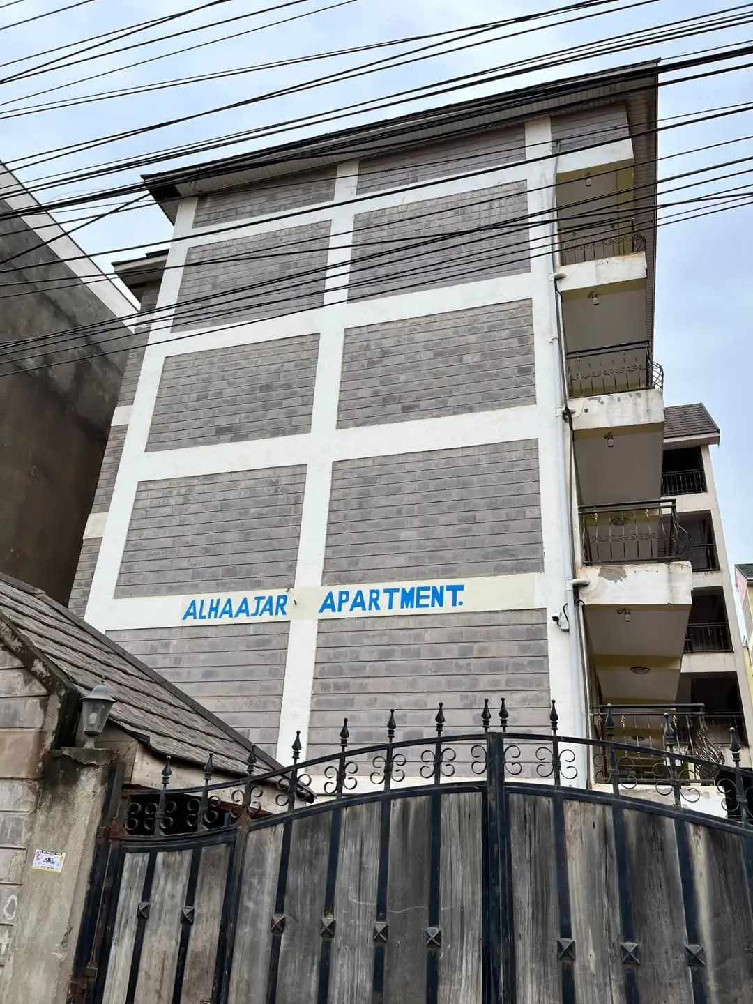 Modern apartment building facade with metal gate entrance