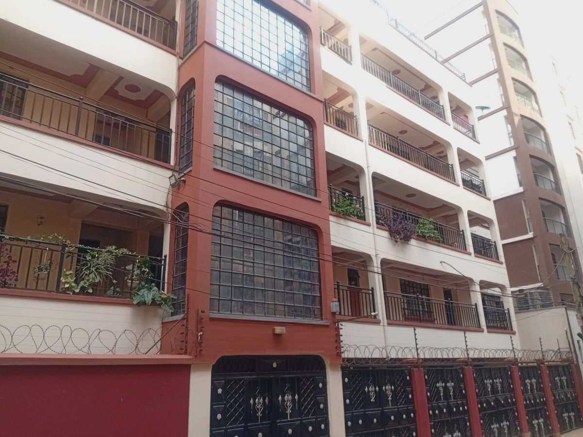 Multi-story residential building facade with red and white sections