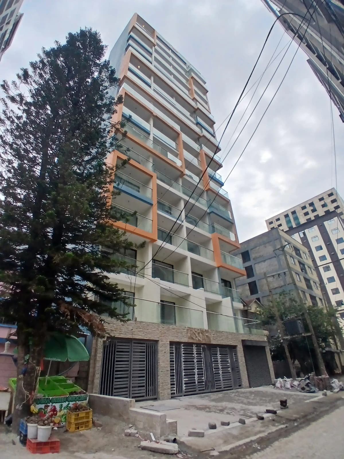 Multi-story residential building facade with ground-floor parking entrance