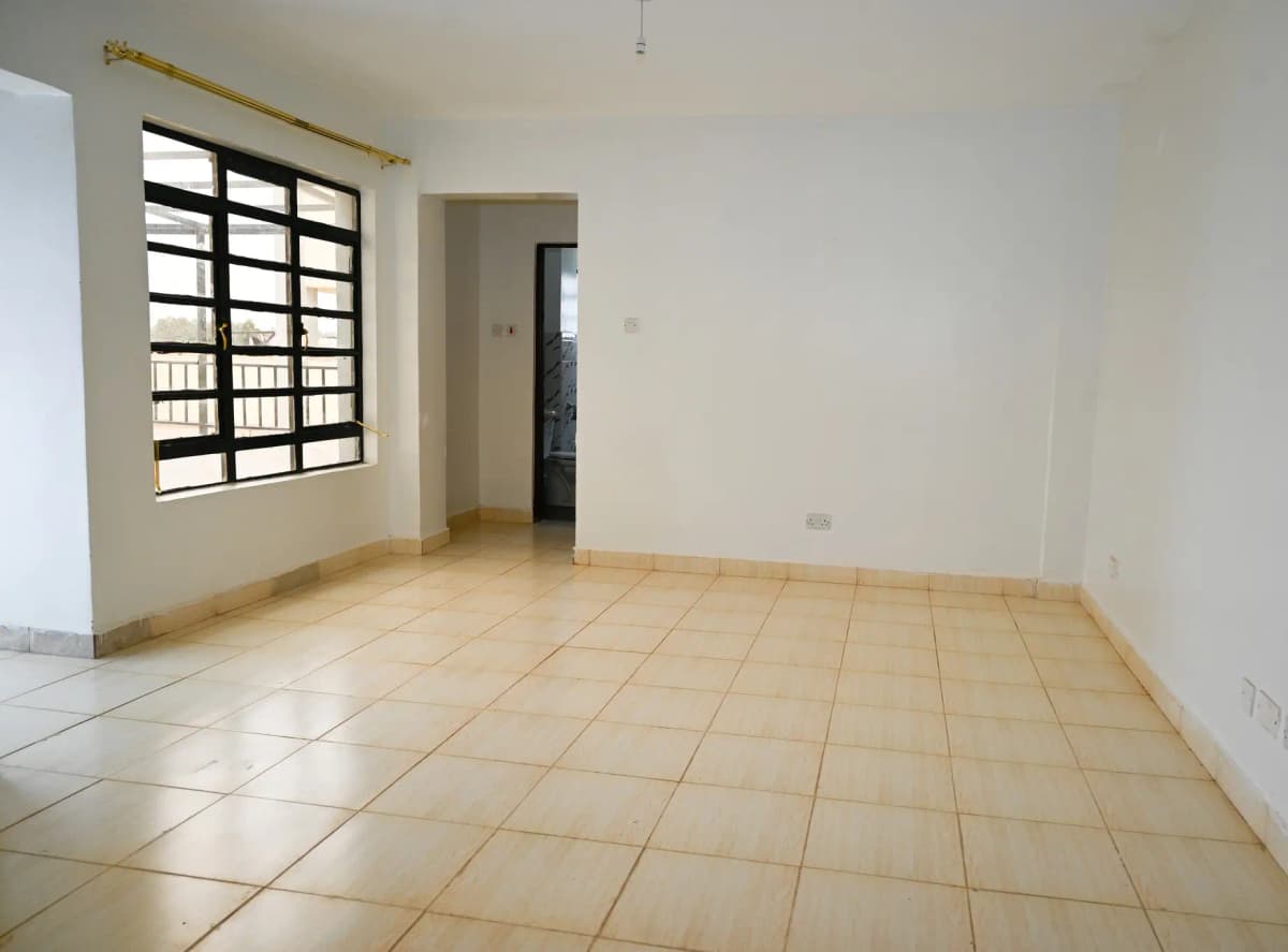 Bright living room with terracotta tiles and barred window