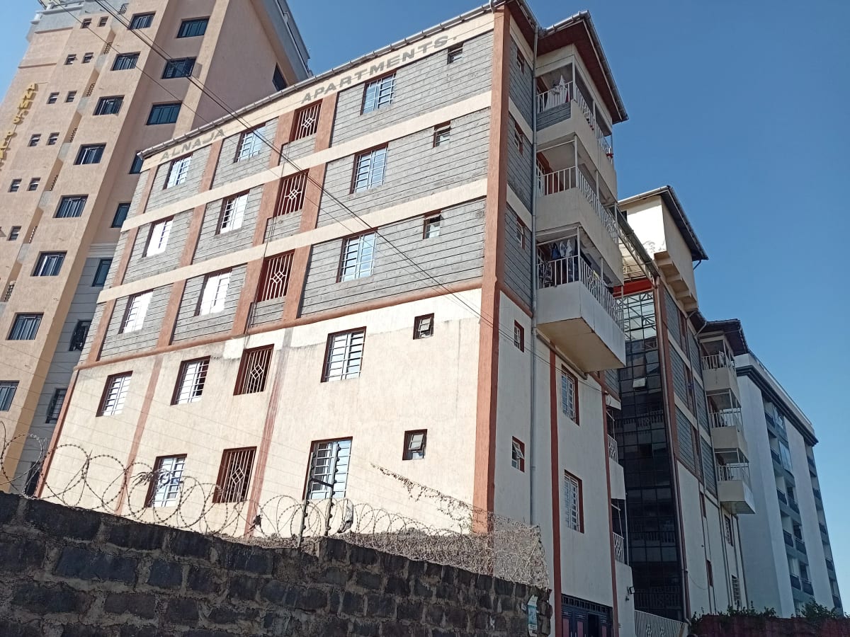 Multi-story residential building facade with blue sky