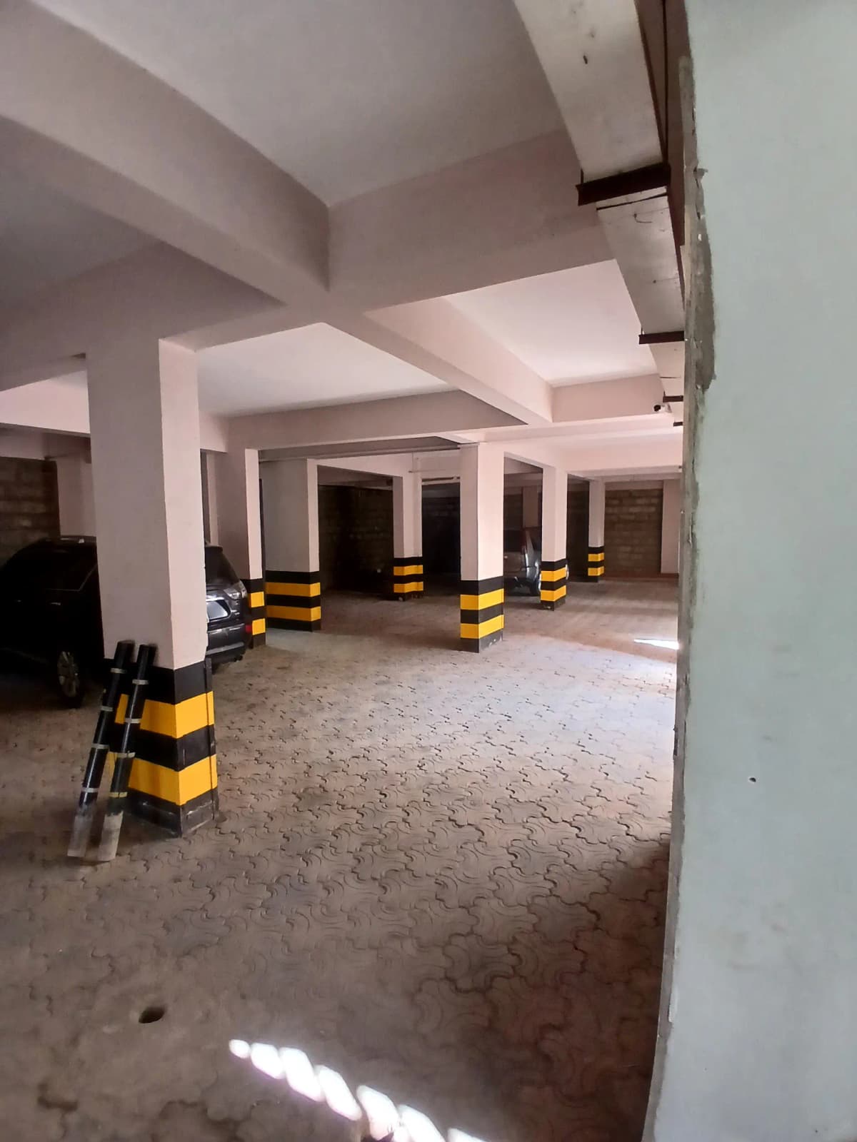 Basement parking level with structural columns and safety bollards