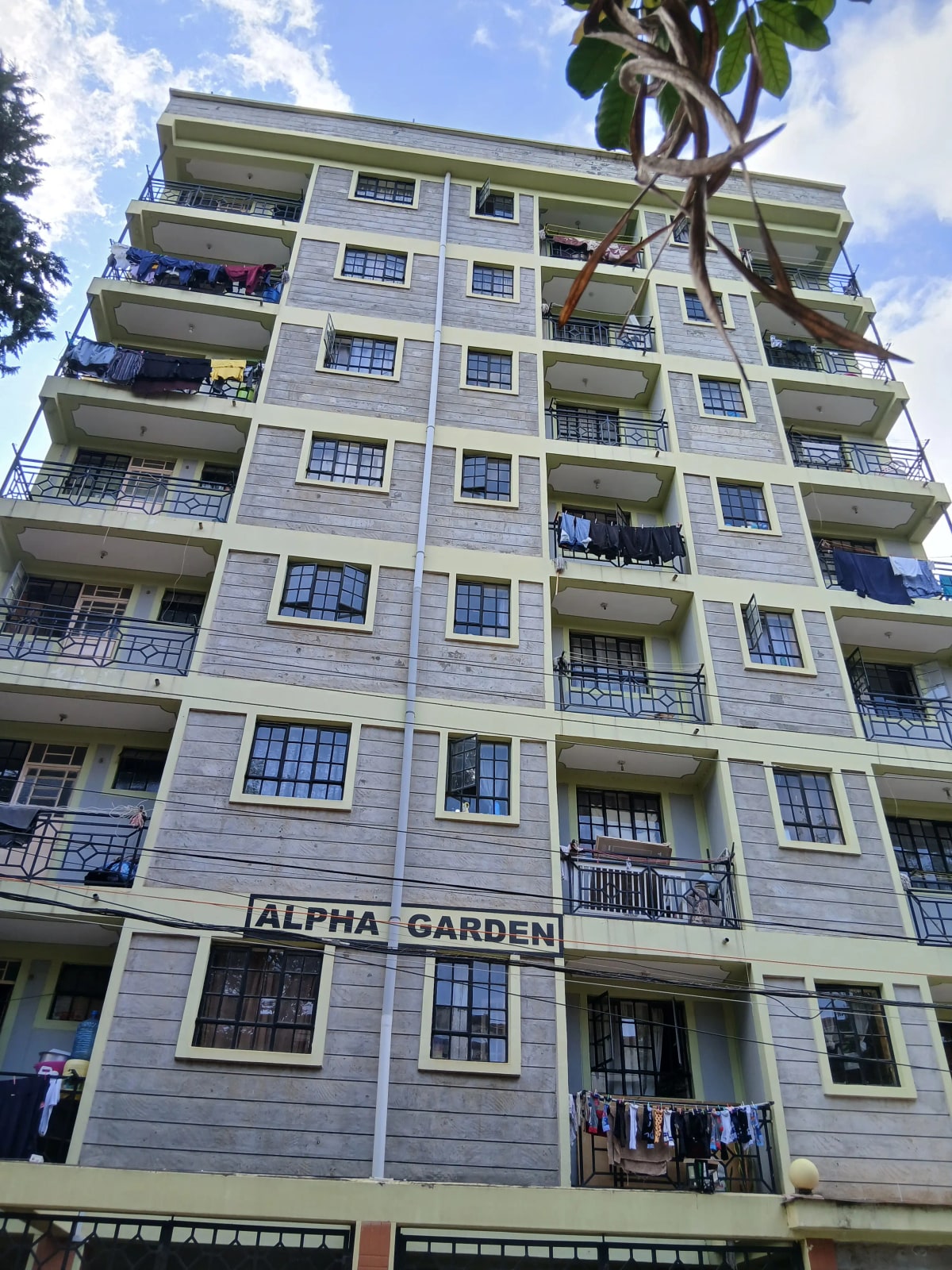 Multi-story residential building facade with balconies and signage