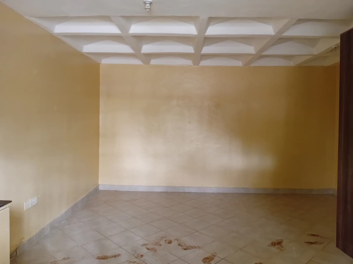 Spacious empty room with coffered ceiling and polished floor