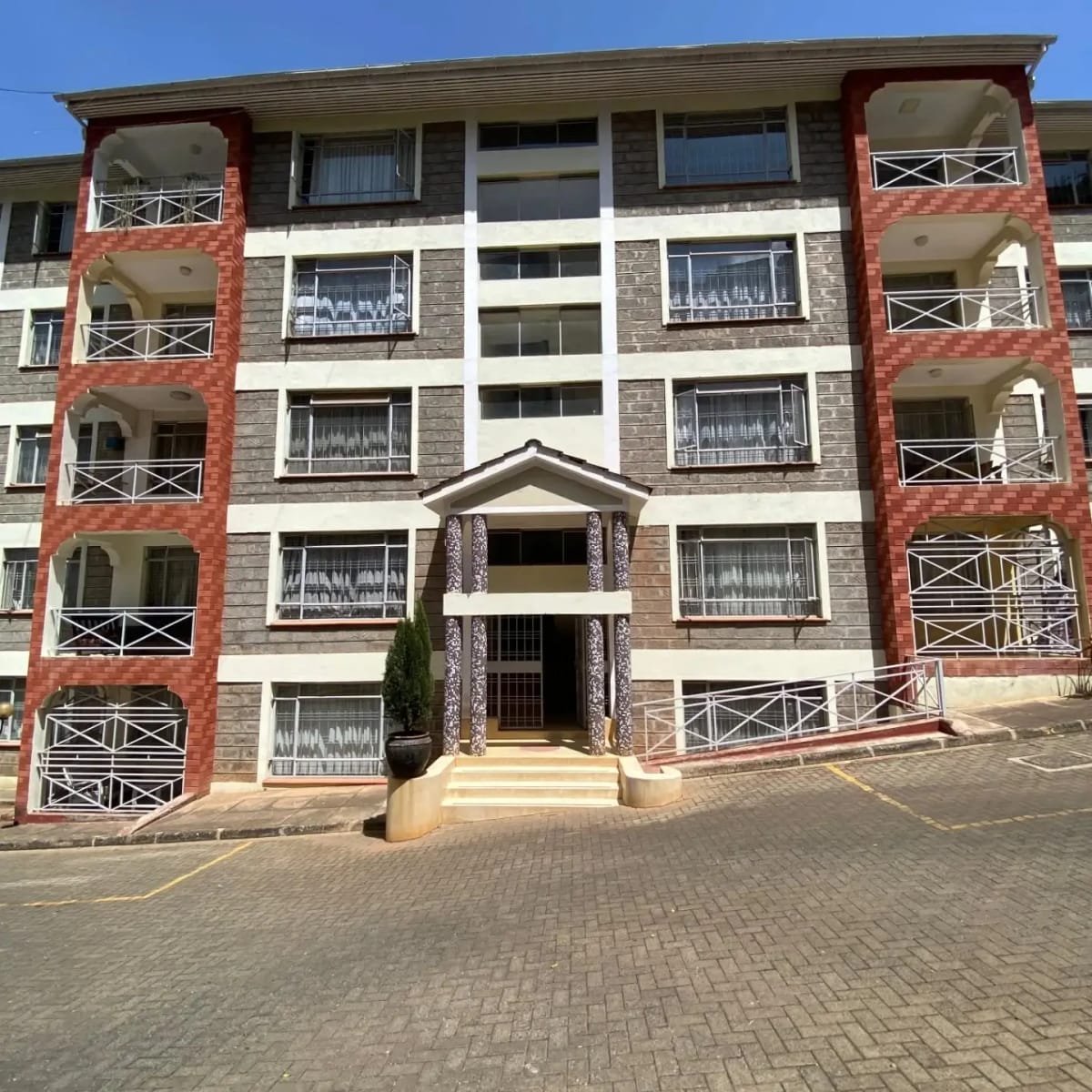 Multi-story apartment building facade with red brick and balconies