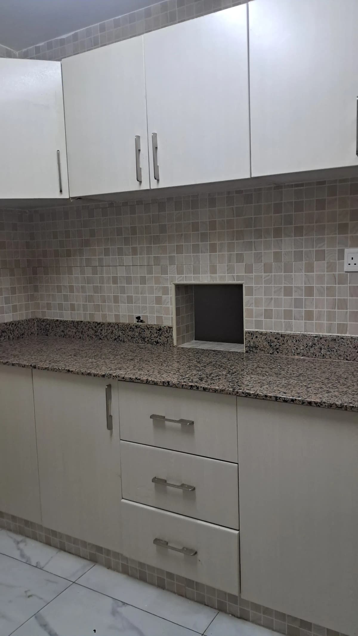 Modern kitchen with white cabinets and granite countertop