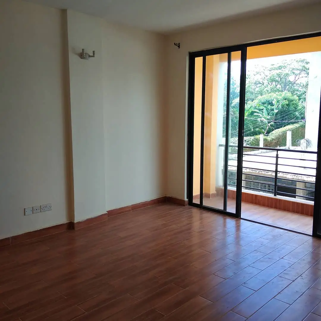 Open-plan living space with sliding glass doors to furnished balcony