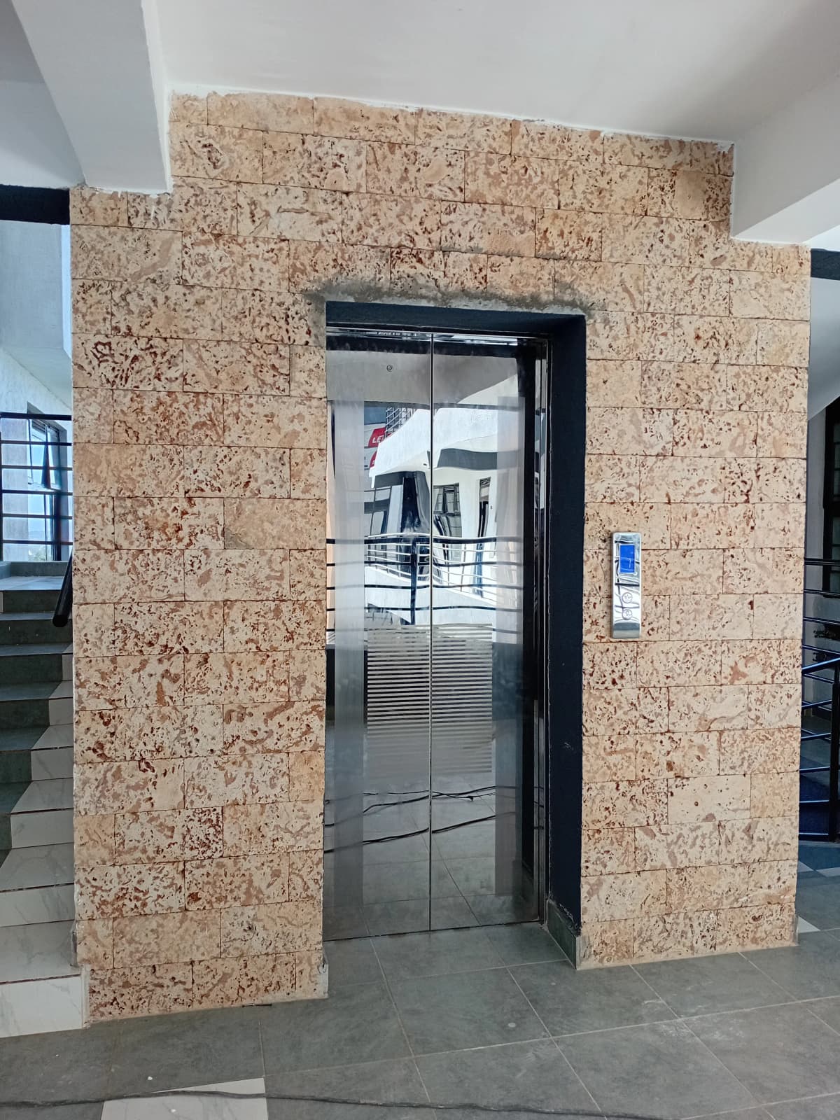 Building lobby with elevator and cork feature wall